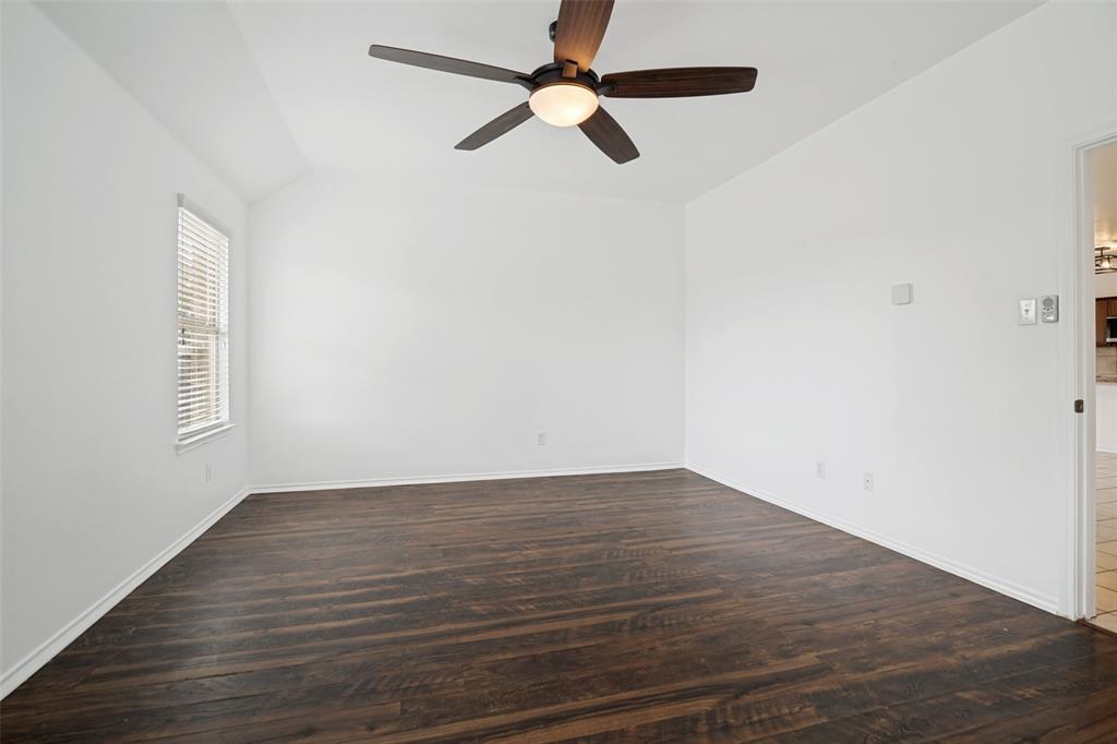 3415 Emerson Road Forney, TX 75126 - Photo 19 of 26 an empty room with wooden floor fan and windows