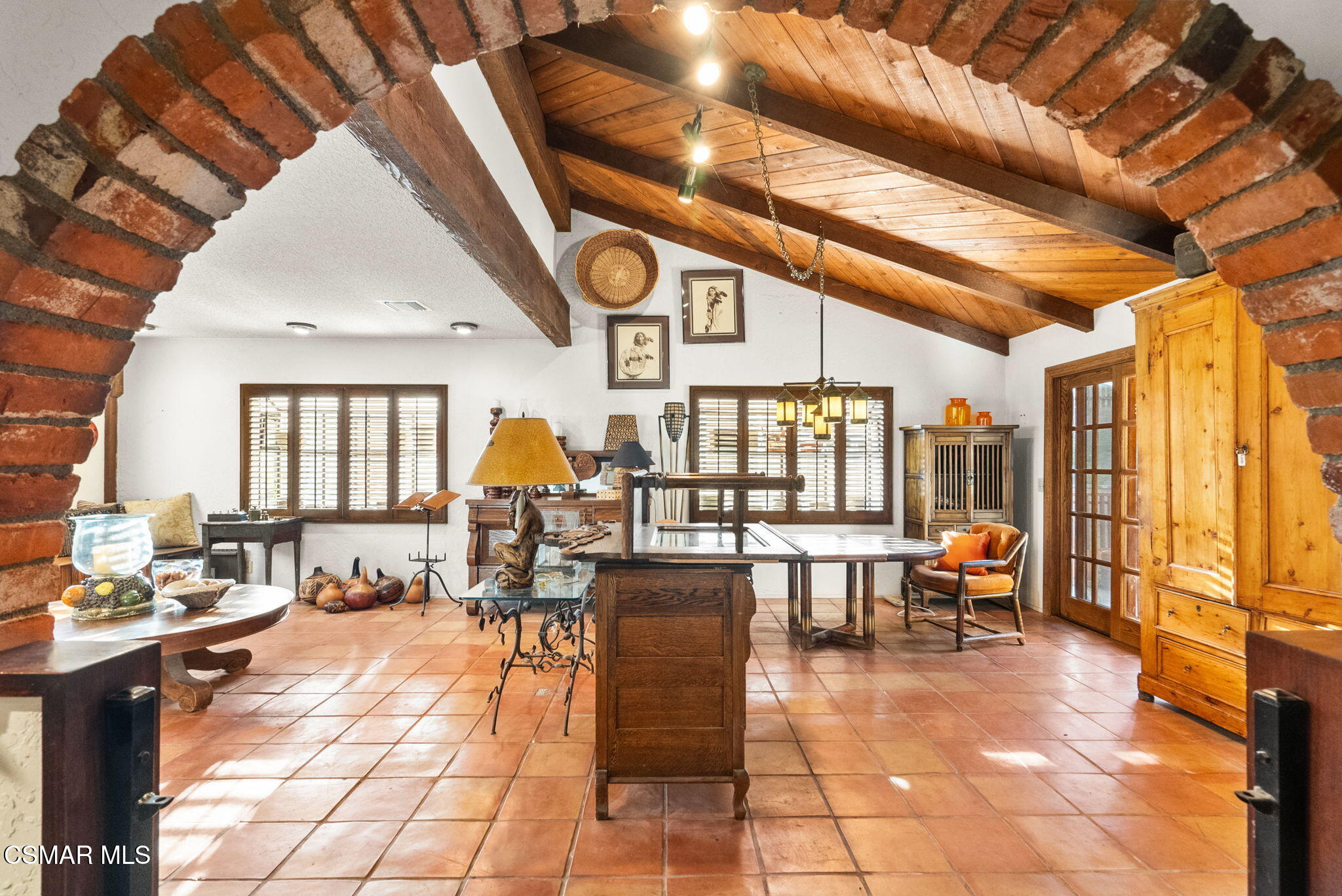 a lobby with furniture and view of living room