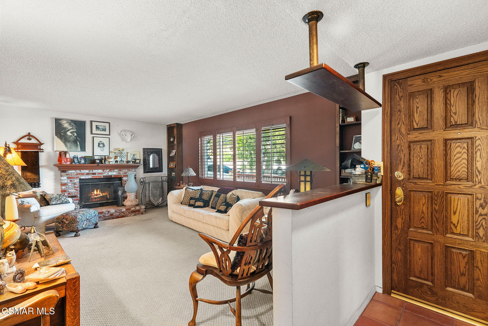 3509 Amarillo Avenue Simi Valley, CA 93063 - Photo 16 of 30 a living room with furniture a fireplace and a large window