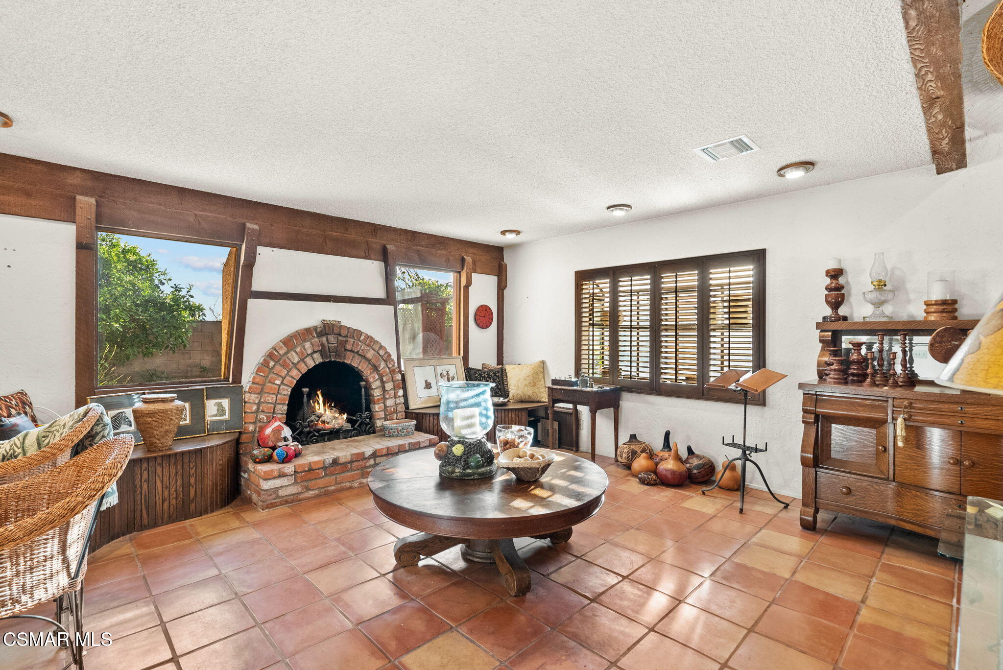 3509 Amarillo Avenue Simi Valley, CA 93063 - Photo 4 of 30 a living room with furniture a fireplace and a table