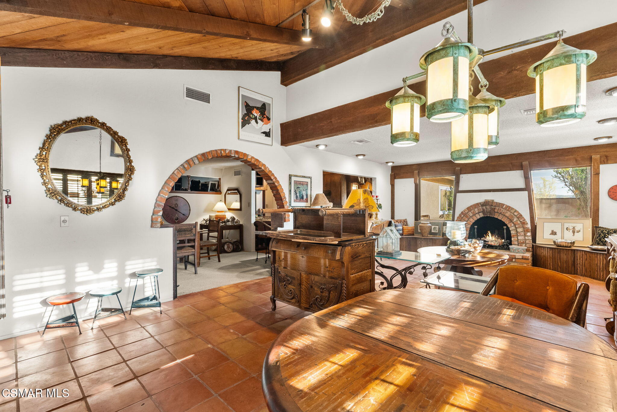 3509 Amarillo Avenue Simi Valley, CA 93063 - Photo 8 of 30 a living room with furniture a fireplace and a dining table with wooden floor