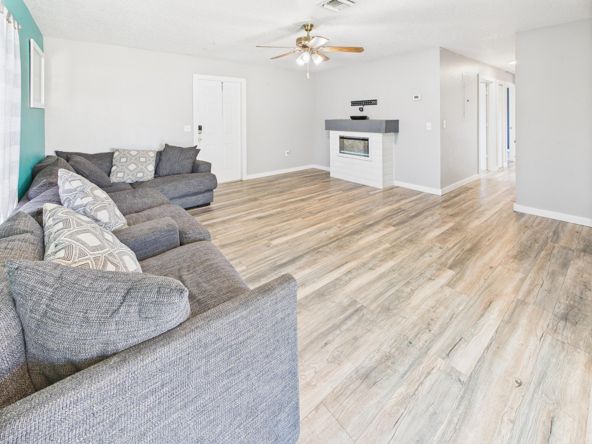 6504 Southeast 86th Boulevard Okeechobee, FL 34974 - Photo 15 of 38 a living room with furniture and a wooden floor