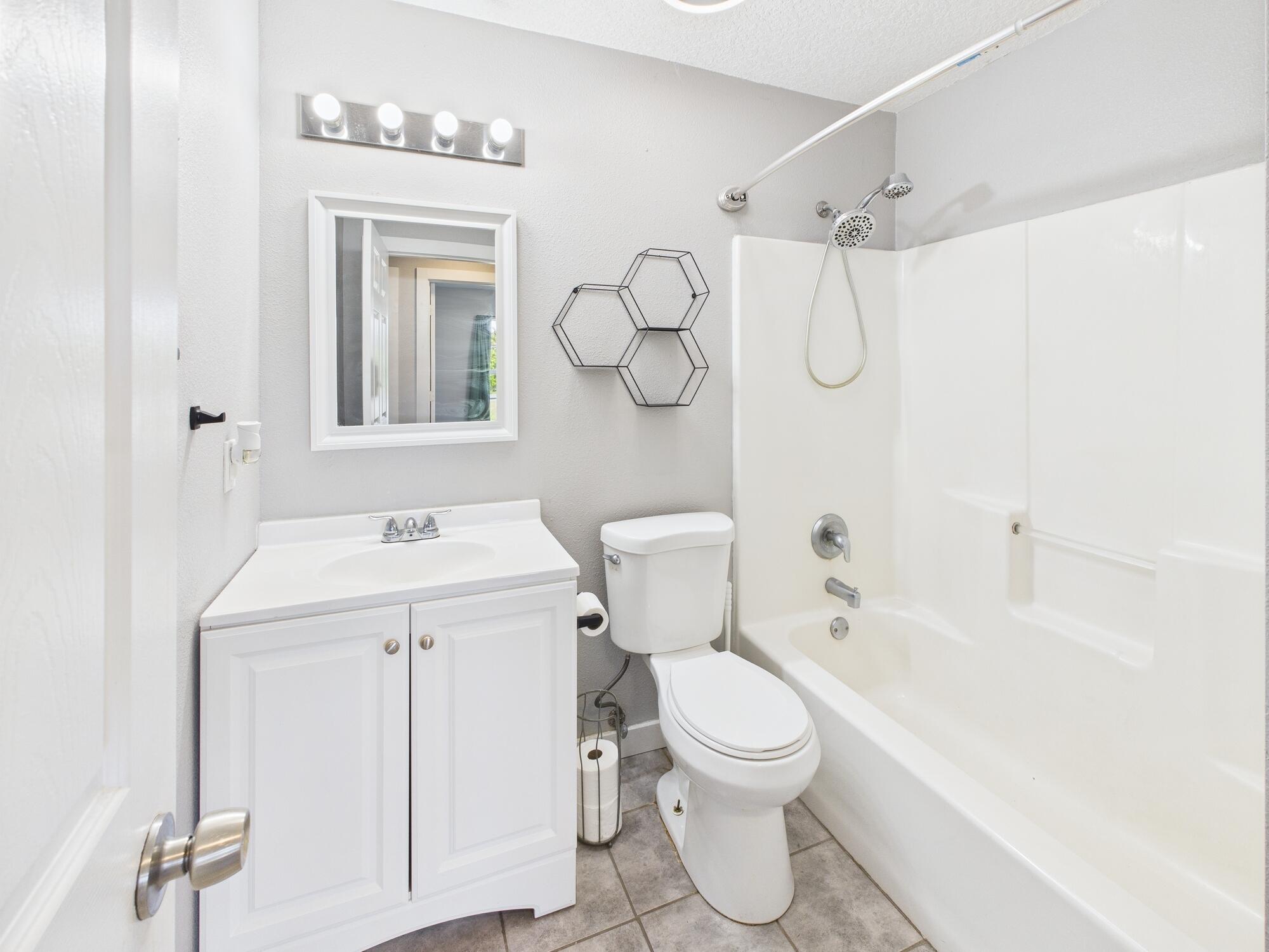 6504 Southeast 86th Boulevard Okeechobee, FL 34974 - Photo 18 of 38 a bathroom with a sink a toilet and shower