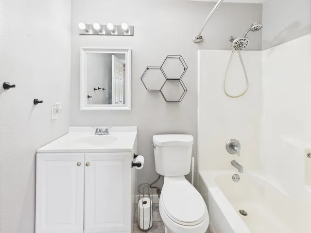 a white toilet sitting next to a bathroom sink