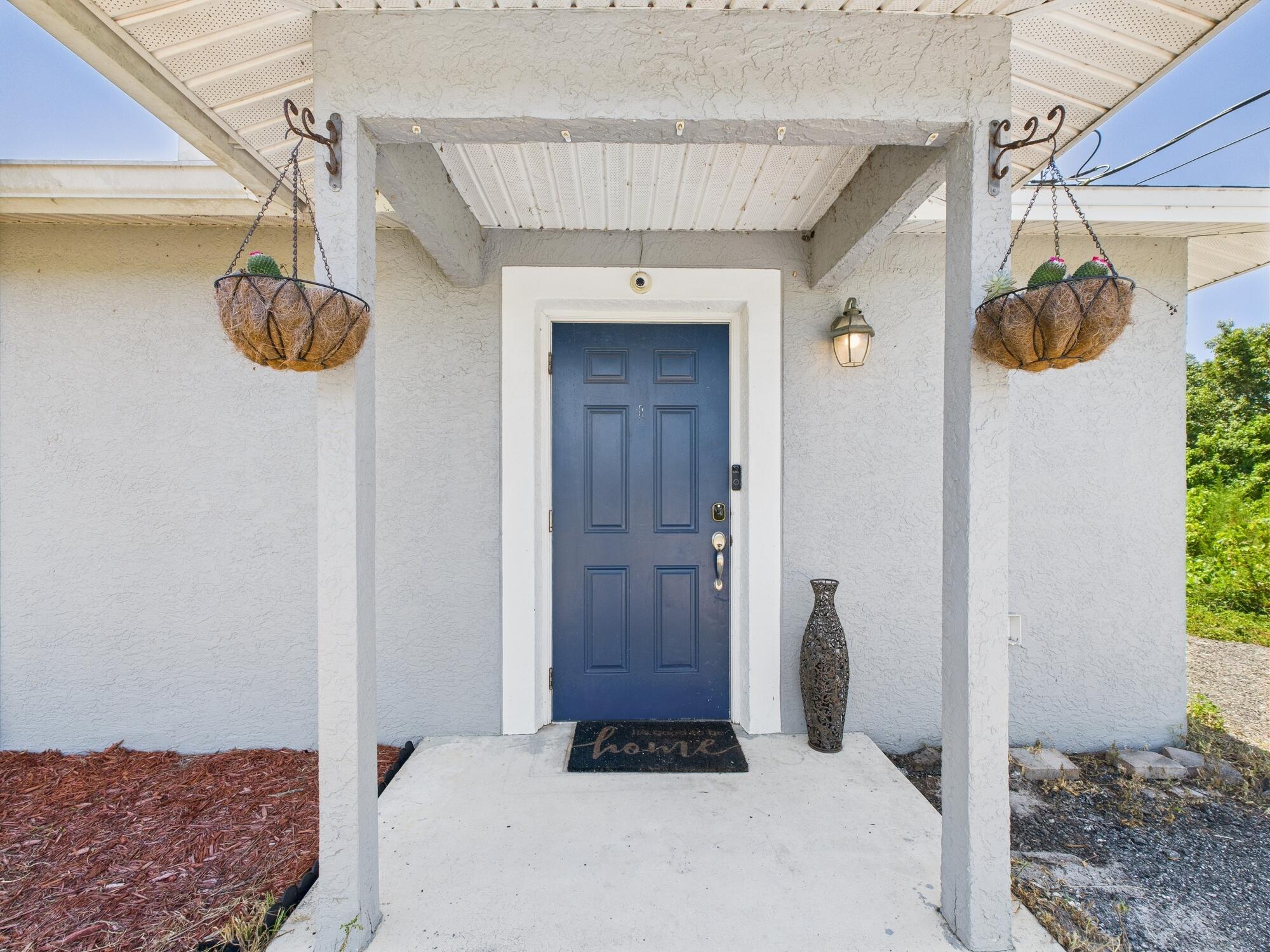 6504 Southeast 86th Boulevard Okeechobee, FL 34974 - Photo 2 of 38 a view of front door and bedroom