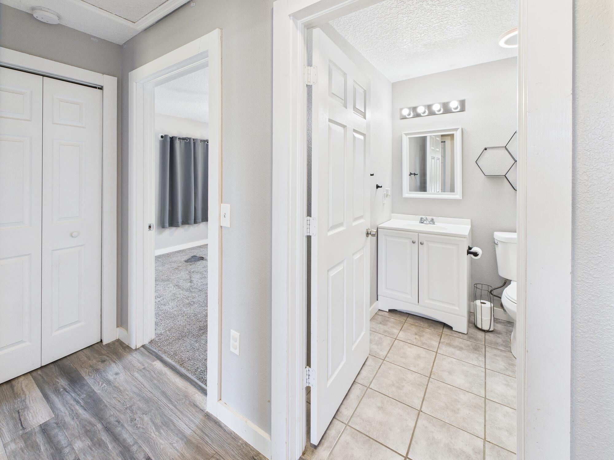 6504 Southeast 86th Boulevard Okeechobee, FL 34974 - Photo 22 of 38 a hallway with white cabinets and wooden floor