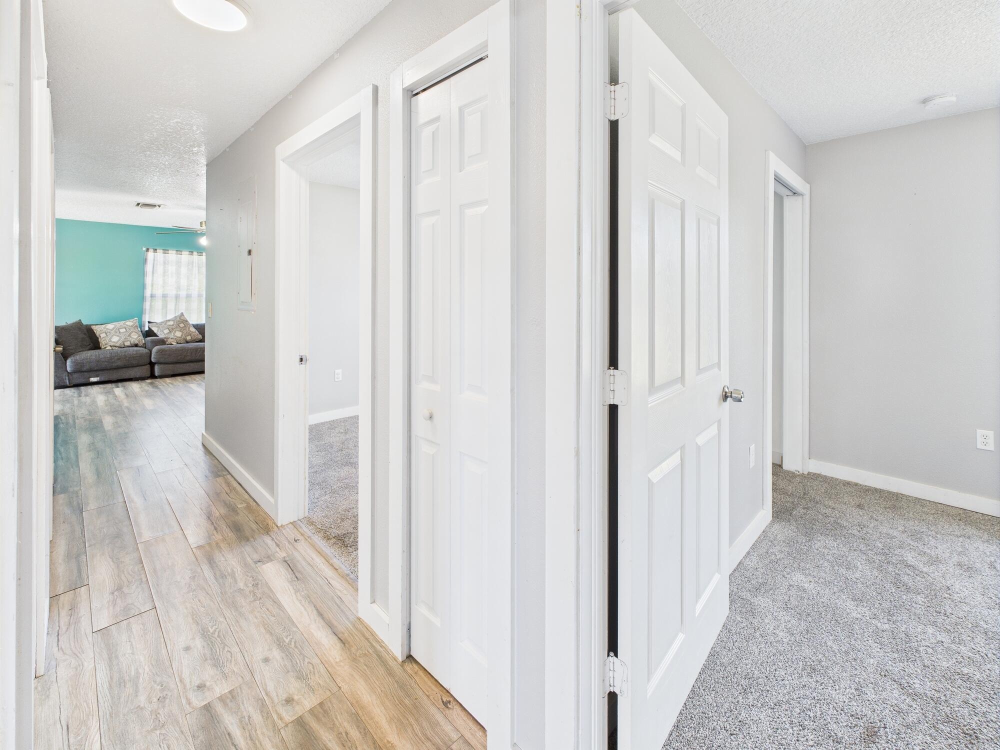 6504 Southeast 86th Boulevard Okeechobee, FL 34974 - Photo 29 of 38 a view of a hallway with wooden floor windows and a livingroom