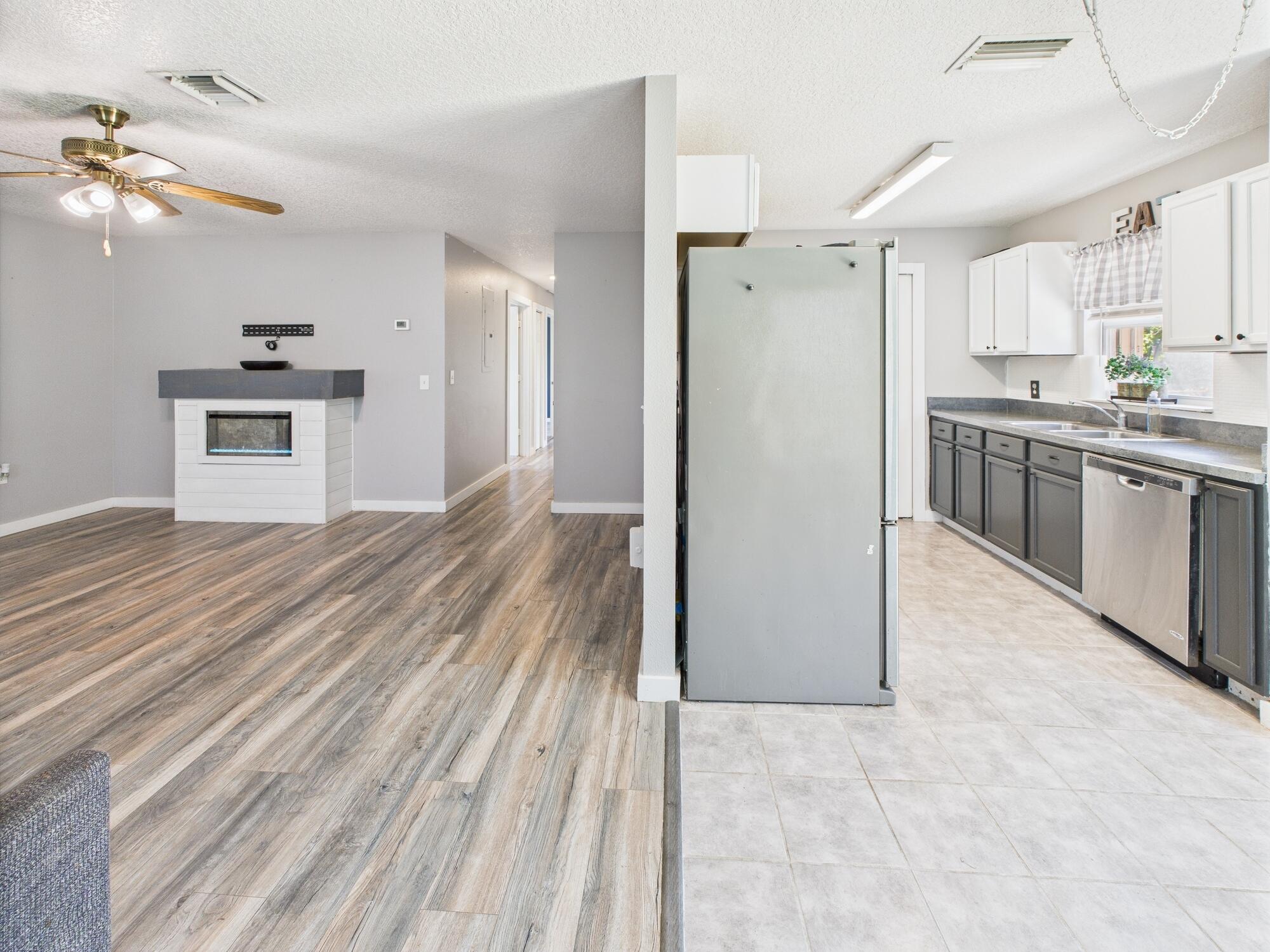 6504 Southeast 86th Boulevard Okeechobee, FL 34974 - Photo 30 of 38 a view of a kitchen with a sink cabinets and refrigerator