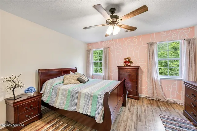 a dining room with furniture and a floor to ceiling window