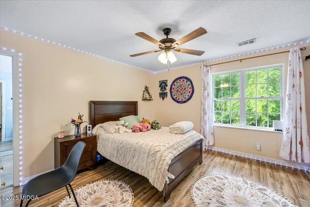 a living room with furniture pool table and a flat screen tv
