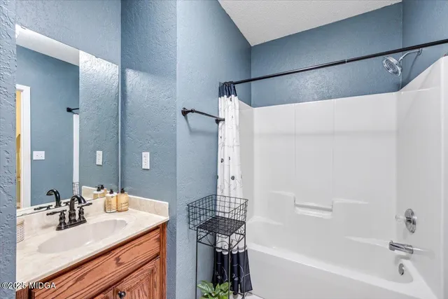 a front view of a house with a yard covered with snow