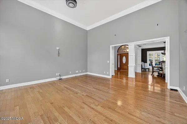 a view of an empty room with a fireplace and a window