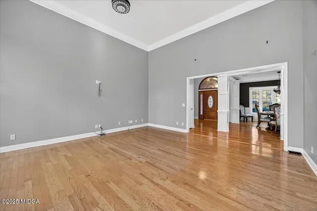a view of an empty room with a fireplace and a window