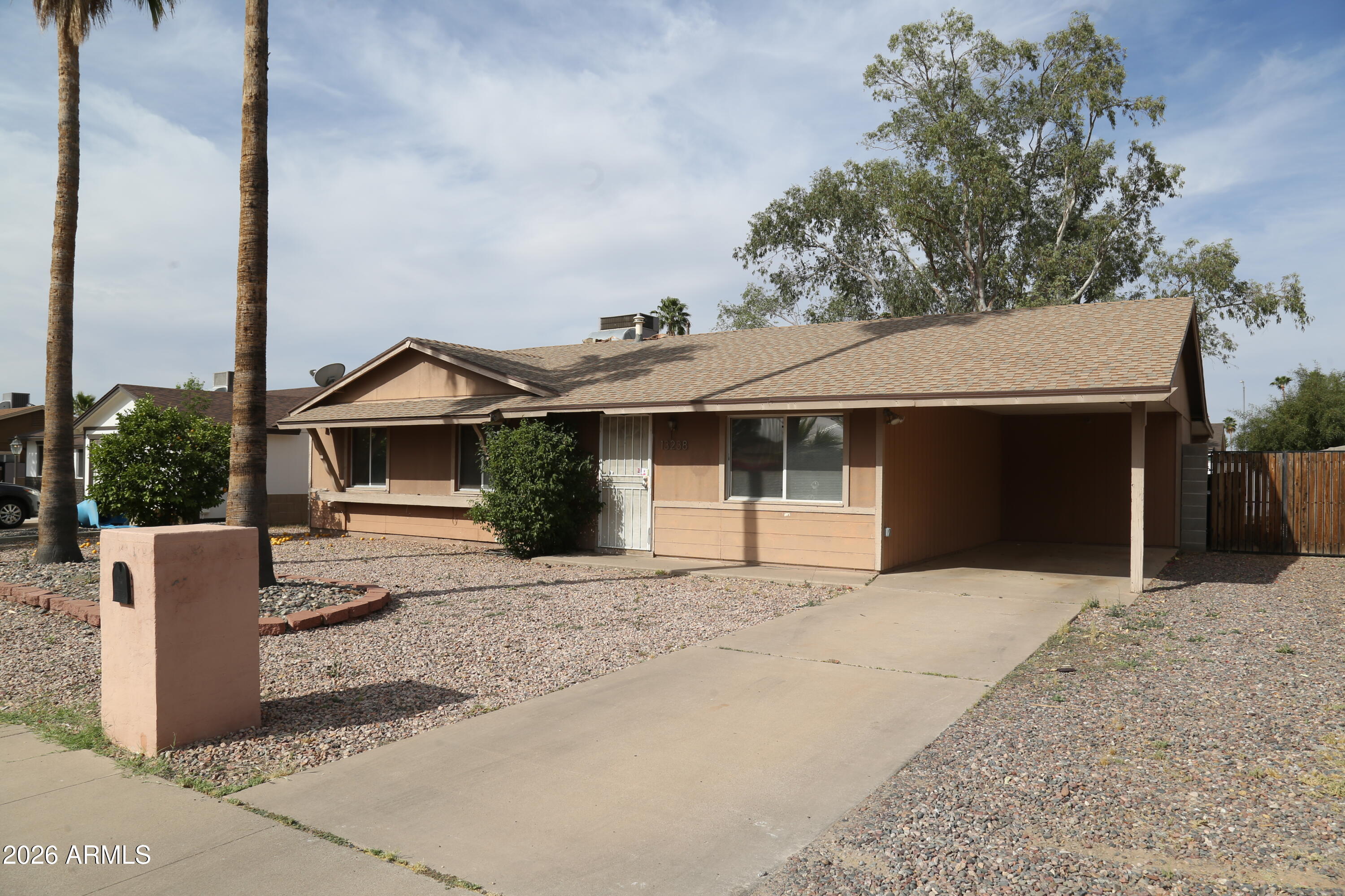 13238 North 38th Place Phoenix, AZ 85032 - Photo 2 of 19 a front view of a house with a yard and garage