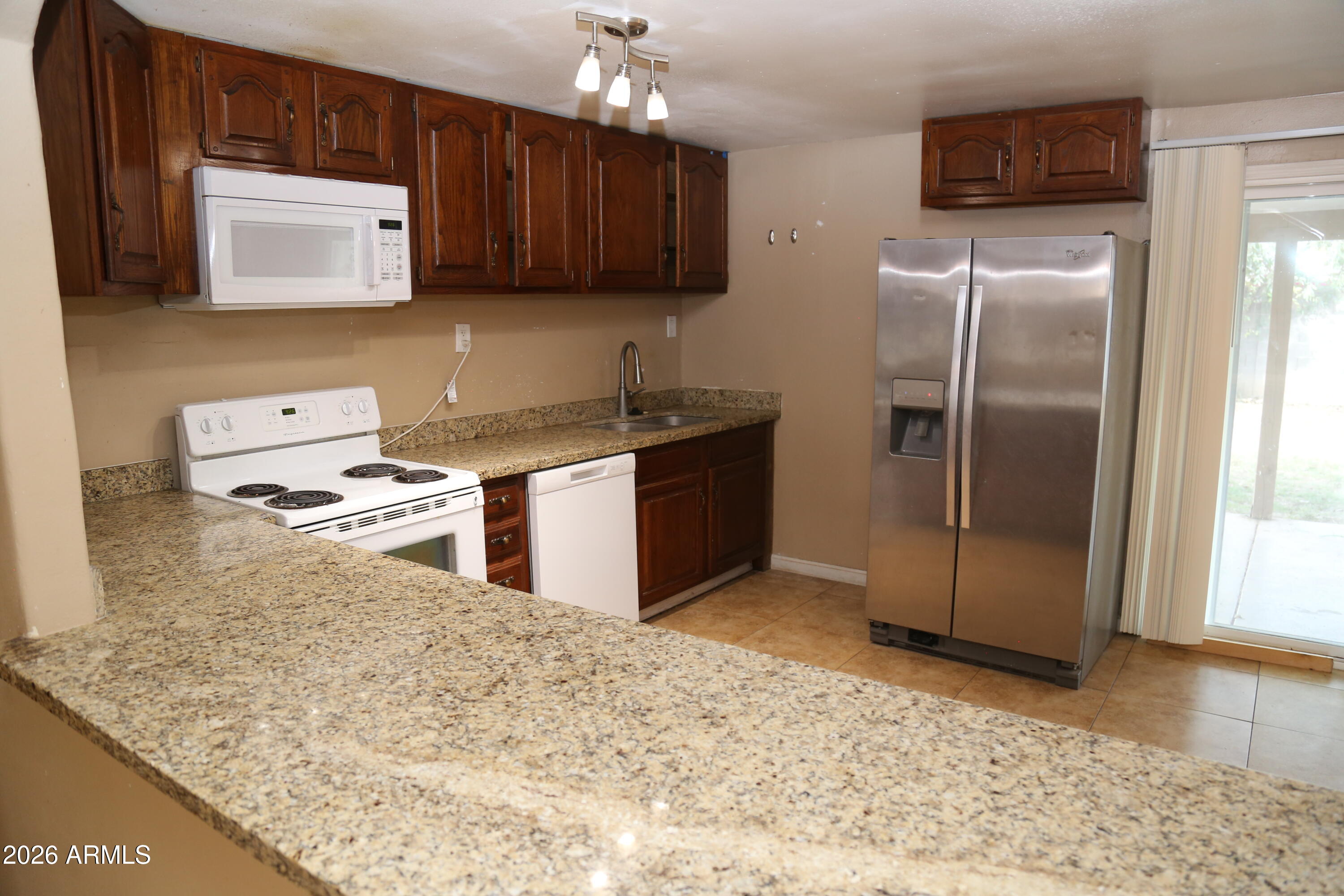 13238 North 38th Place Phoenix, AZ 85032 - Photo 7 of 19 a kitchen with stainless steel appliances granite countertop a refrigerator a stove a sink and dishwasher