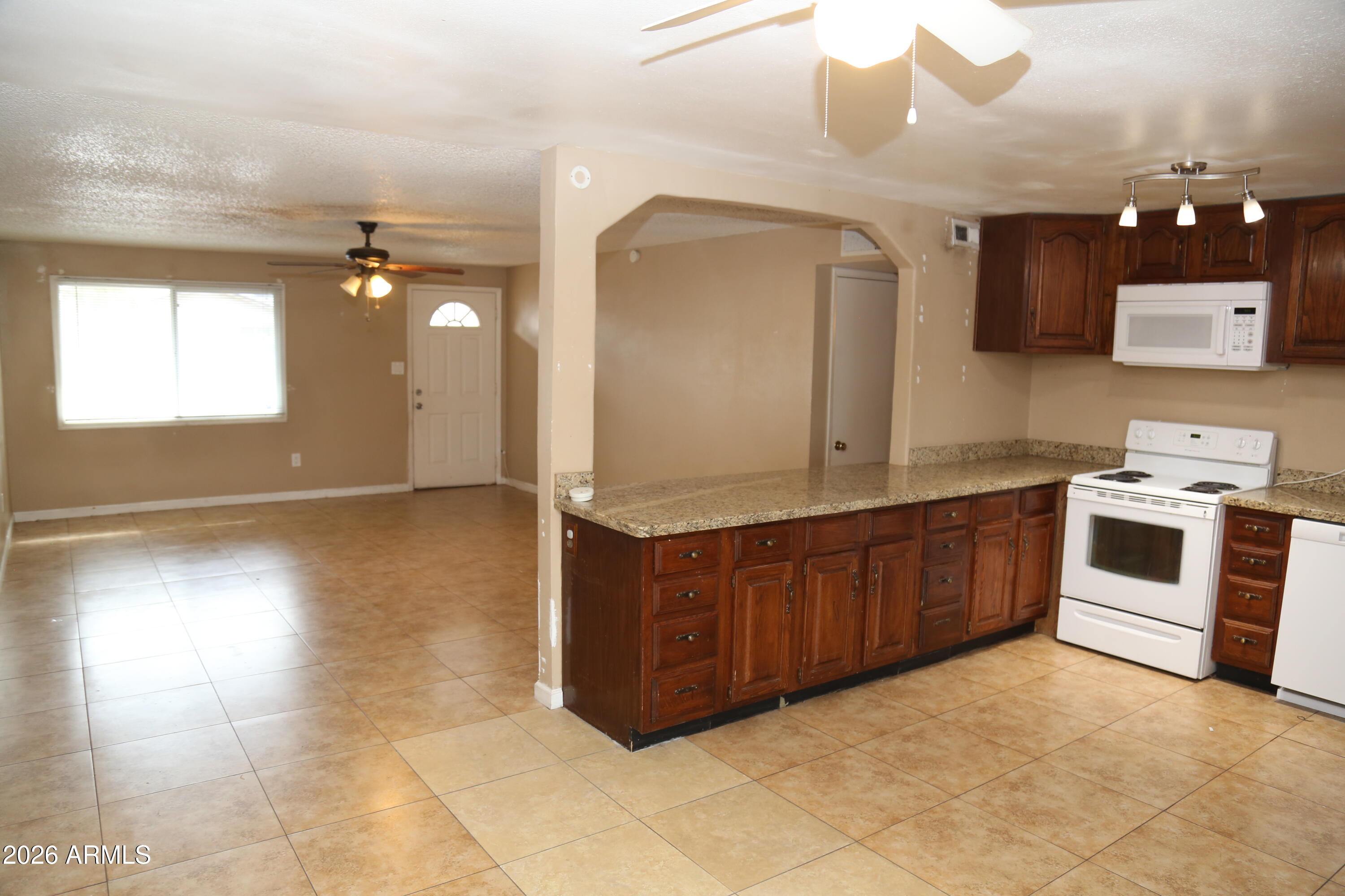 13238 North 38th Place Phoenix, AZ 85032 - Photo 9 of 19 a kitchen with stainless steel appliances granite countertop a stove a sink and a microwave