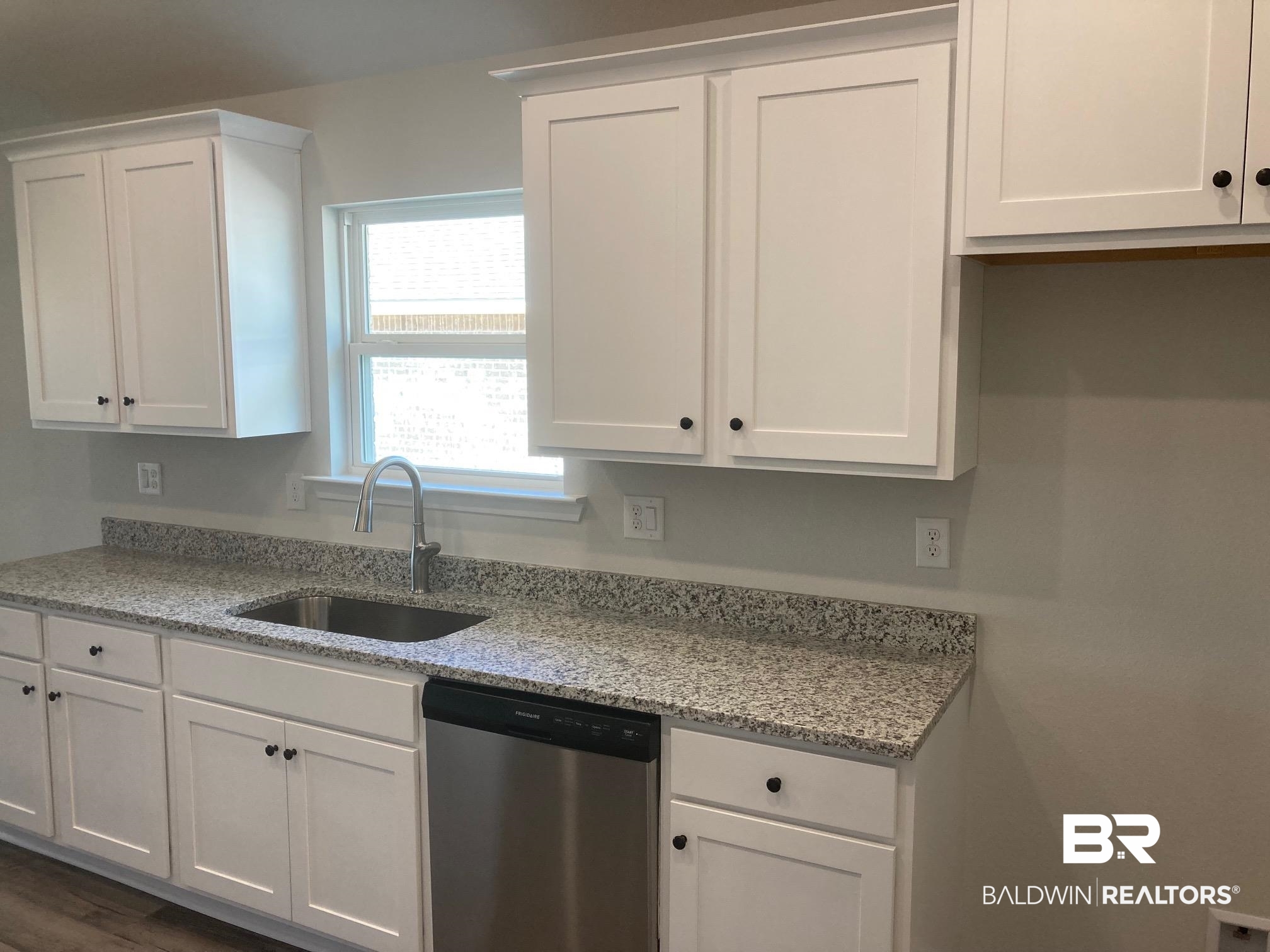 629 Revere Street Foley, AL 36535 - Photo 13 of 30 Kitchen with white cabinets, stainless steel dishwasher, and sink