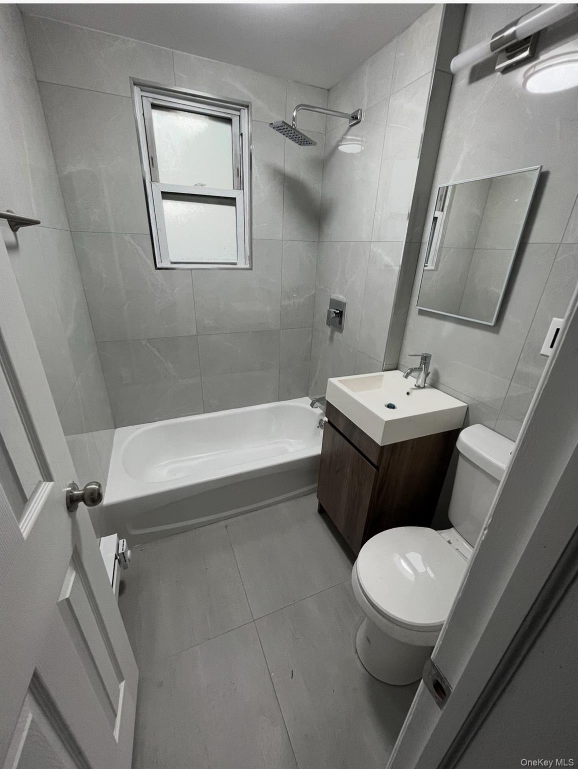 211-45 Jamaica Avenue Queens, NY 11428 - Photo 4 of 4 a white toilet sitting next to a bath tub