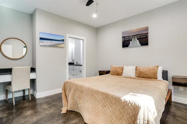 a bedroom with a bed a desk and chair