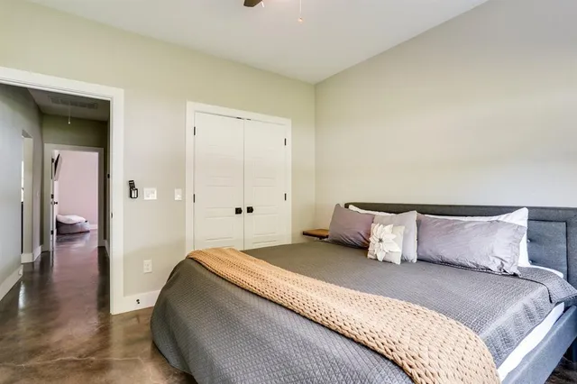 a bedroom with a bed and wooden floor