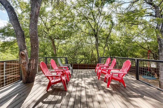 an outdoor sitting area with couch and wooden shade