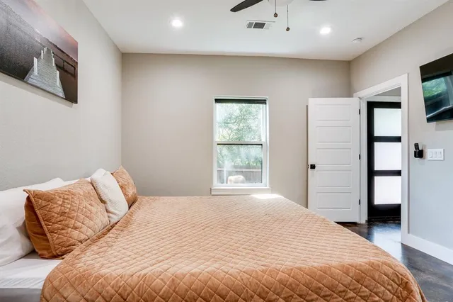 a bedroom with a bed cabinet and mirror