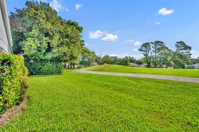 a view of a house with backyard and garden