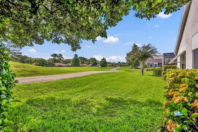 a view of a white and patio with a garden
