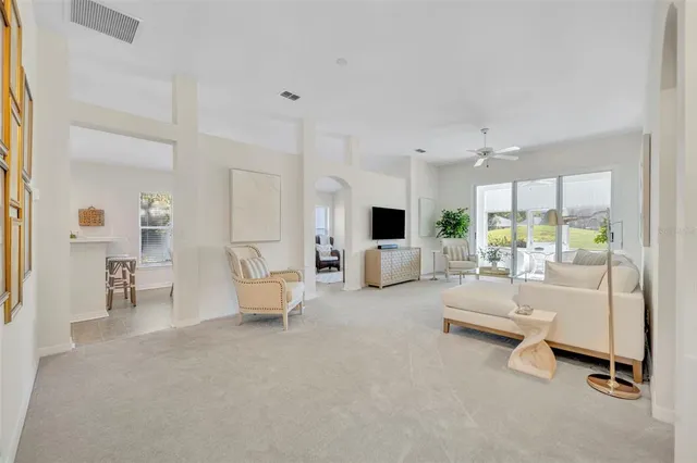 a living room with furniture and a chandelier