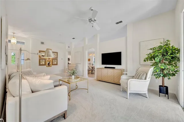 a view of a dining room with furniture and a chandelier