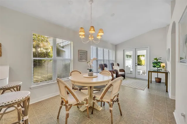 a kitchen with a sink white cabinets and appliances