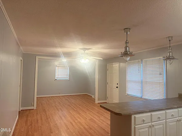 a view of a kitchen with a sink and wooden floor