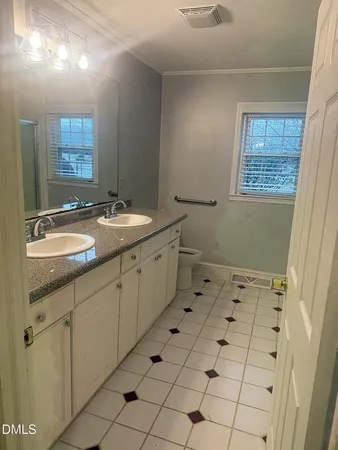 a bathroom with a sink toilet and mirror