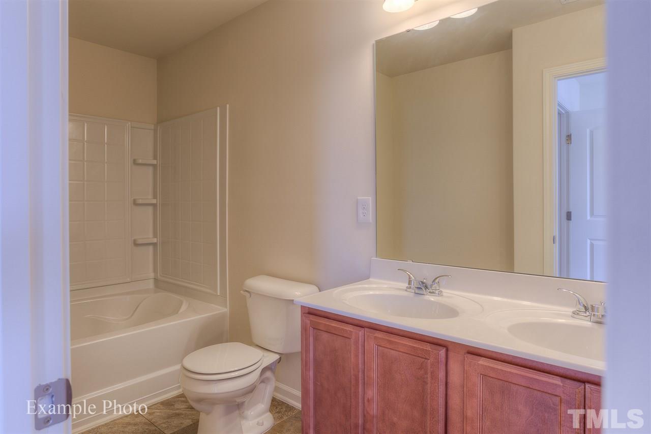 9673 Jernigan Road Spring Hope, NC 27882 - Photo 20 of 24 a bathroom with a granite countertop sink toilet and shower