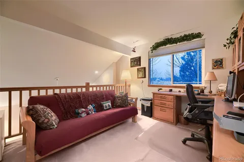 a reading room with furniture and a window