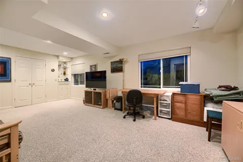 a livingroom with workspace and a window