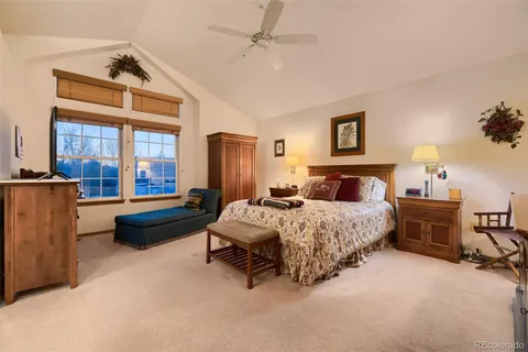 a spacious bedroom with a bed and a chandelier