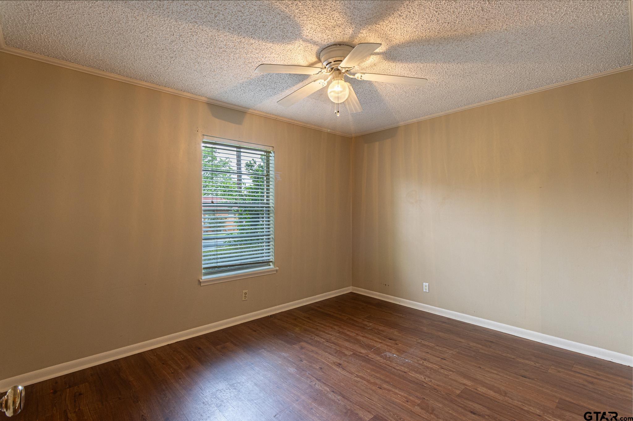 1202 Ridgeview Drive Tyler, TX 75701 - Photo 11 of 20 an empty room with wooden floor and windows