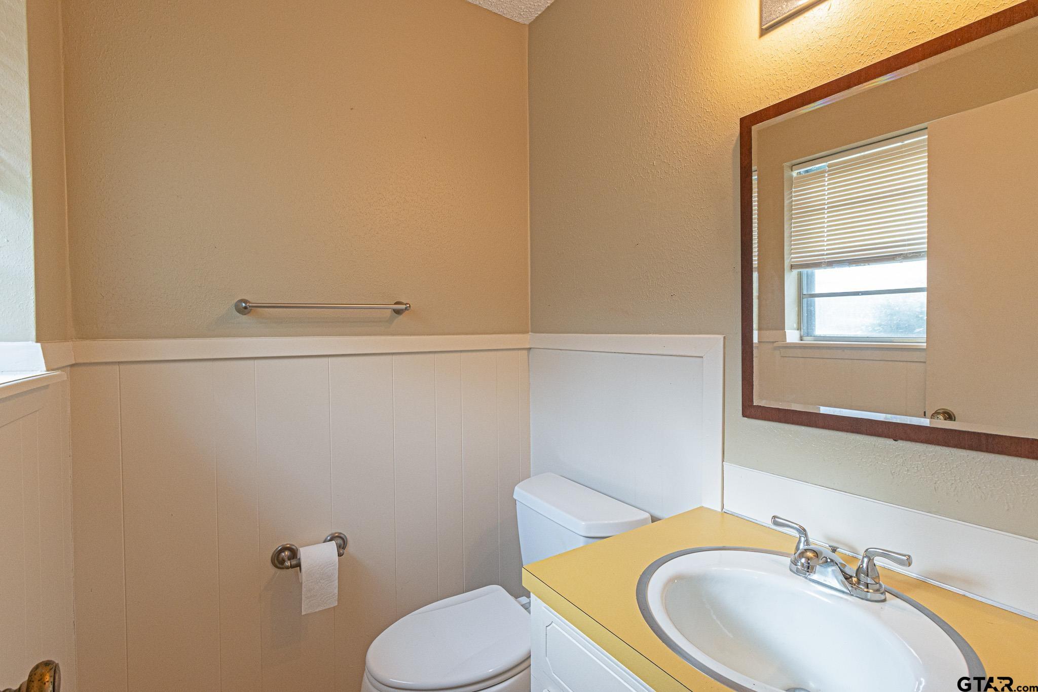 1202 Ridgeview Drive Tyler, TX 75701 - Photo 14 of 20 a bathroom with a sink a toilet and mirror