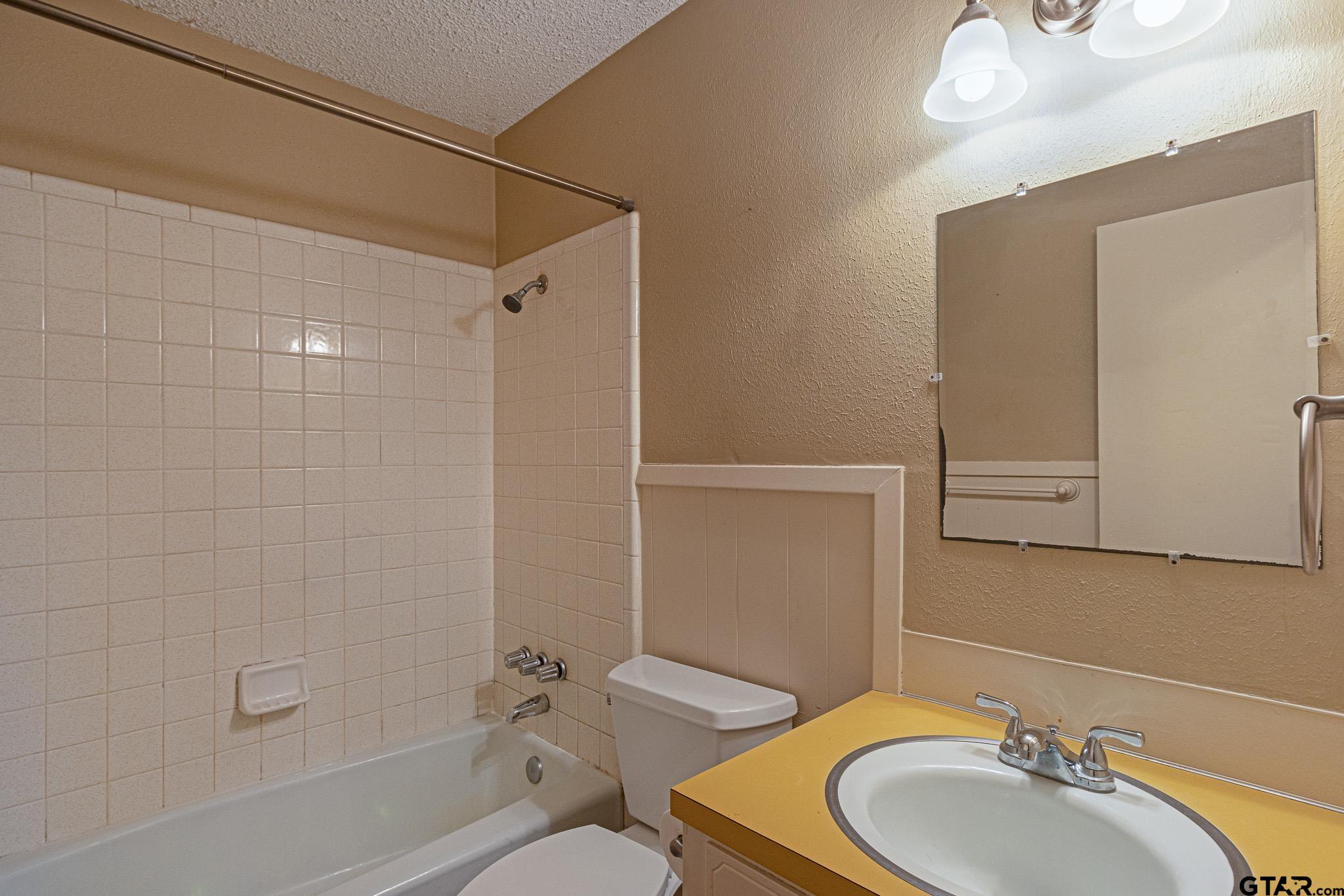 1202 Ridgeview Drive Tyler, TX 75701 - Photo 19 of 20 a bathroom with a sink toilet and shower