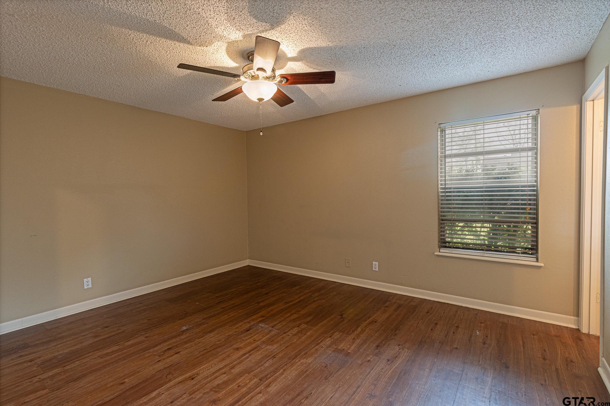 1202 Ridgeview Drive Tyler, TX 75701 - Photo 20 of 20 a view of a room with wooden floor and chandelier fan
