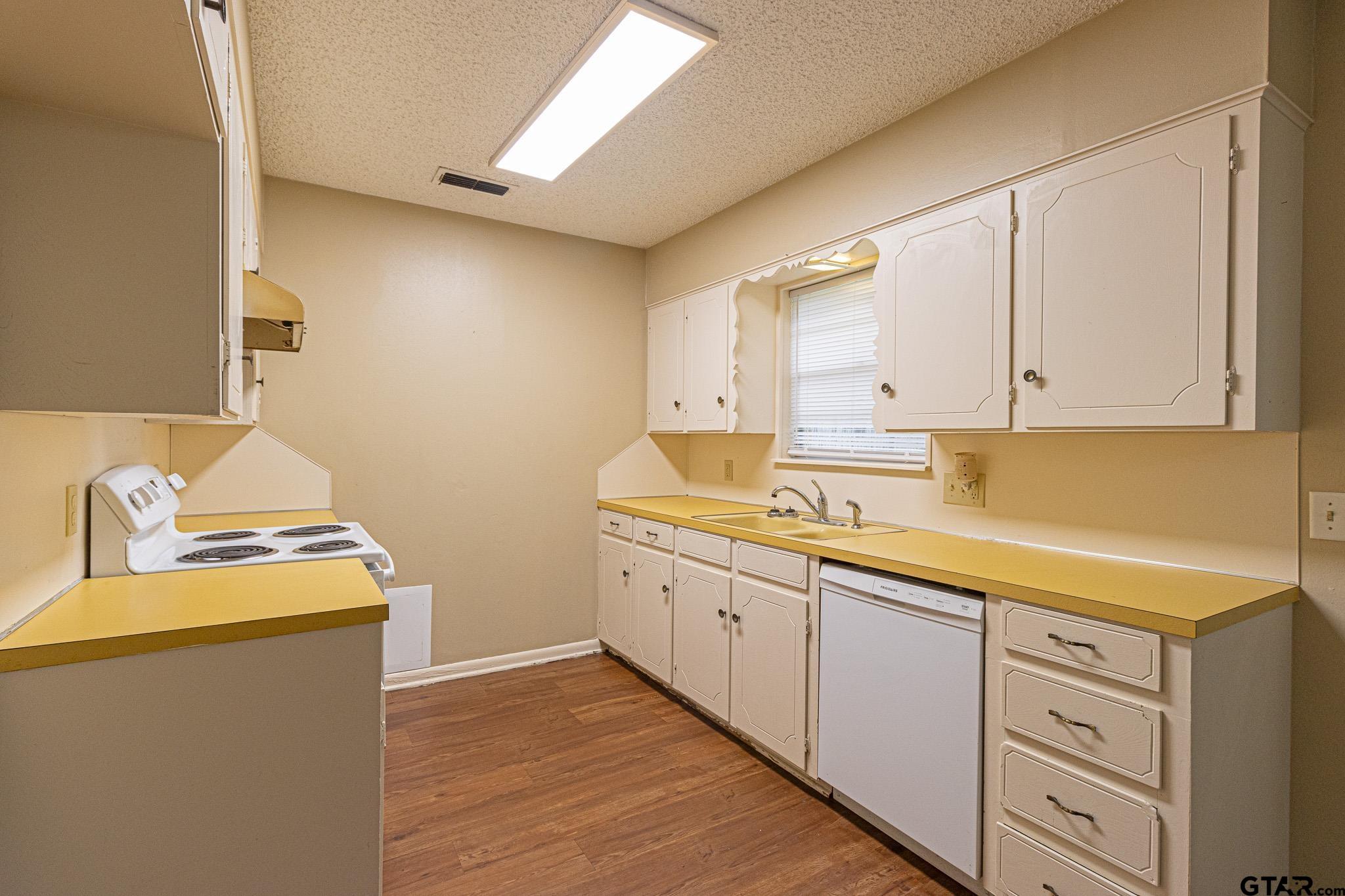 1202 Ridgeview Drive Tyler, TX 75701 - Photo 5 of 20 a kitchen with sink stove and cabinets