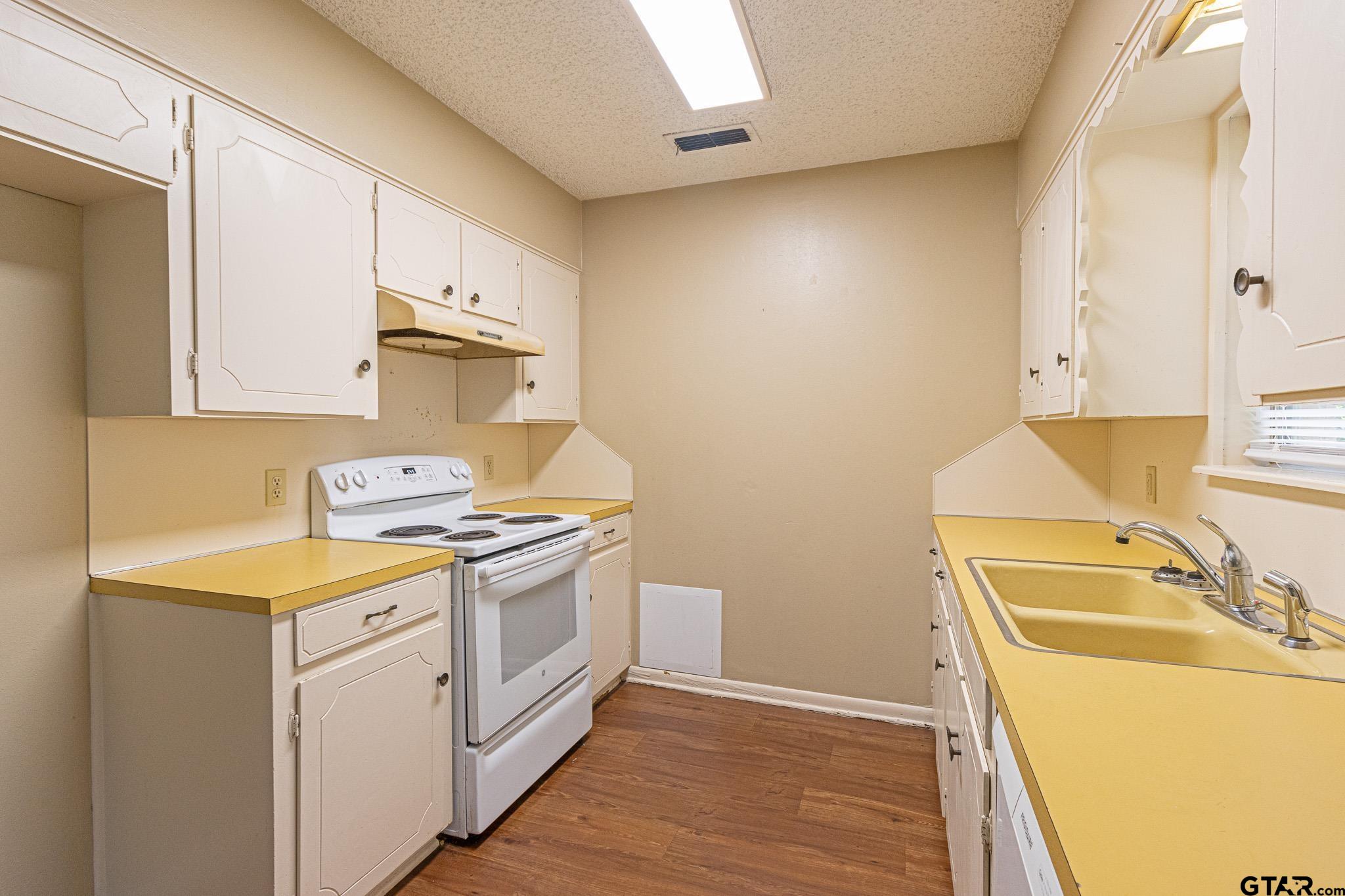 1202 Ridgeview Drive Tyler, TX 75701 - Photo 6 of 20 a kitchen with a sink stove and cabinets