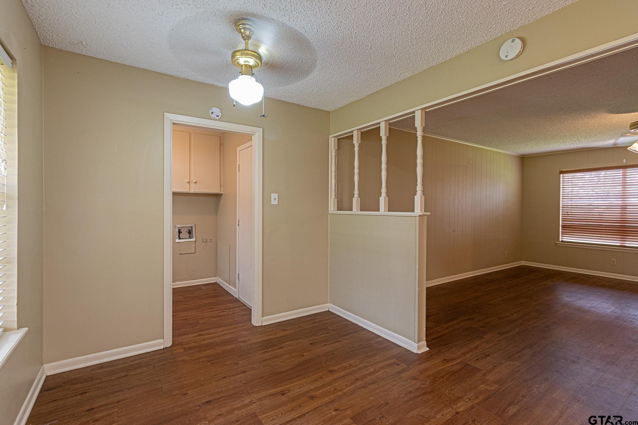 1202 Ridgeview Drive Tyler, TX 75701 - Photo 8 of 20 an empty room with wooden floor and windows
