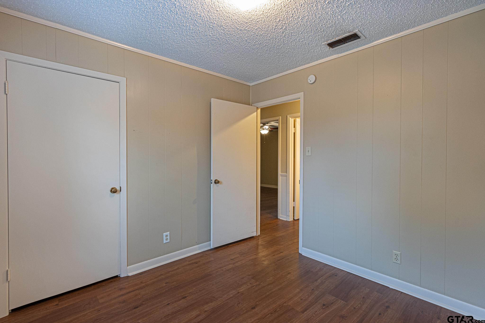 1202 Ridgeview Drive Tyler, TX 75701 - Photo 10 of 20 a view of an empty room with wooden floor