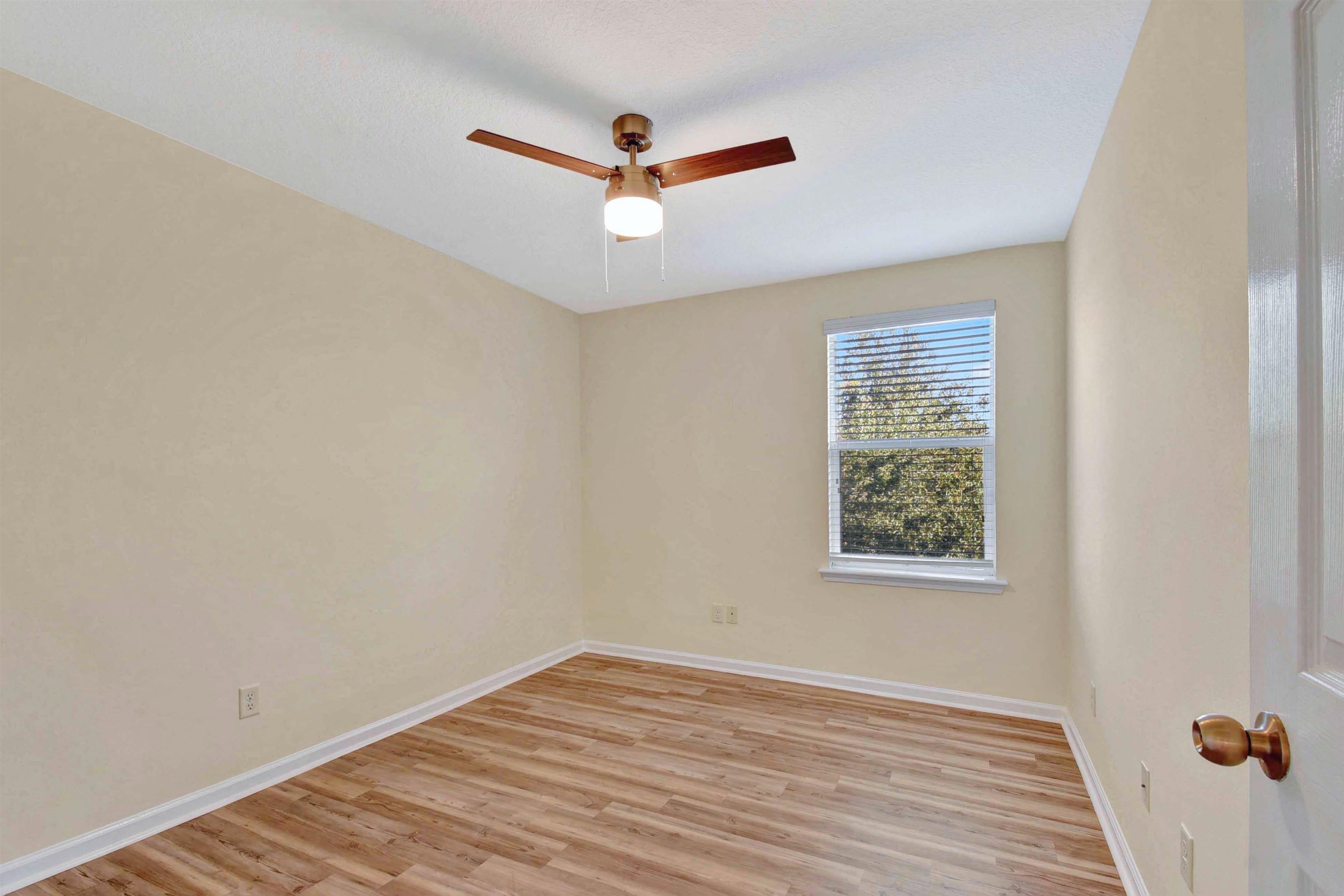 617 Golden Lake Loop St. Augustine, FL 32084 - Photo 11 of 25 a view of empty room with wooden floor and fan