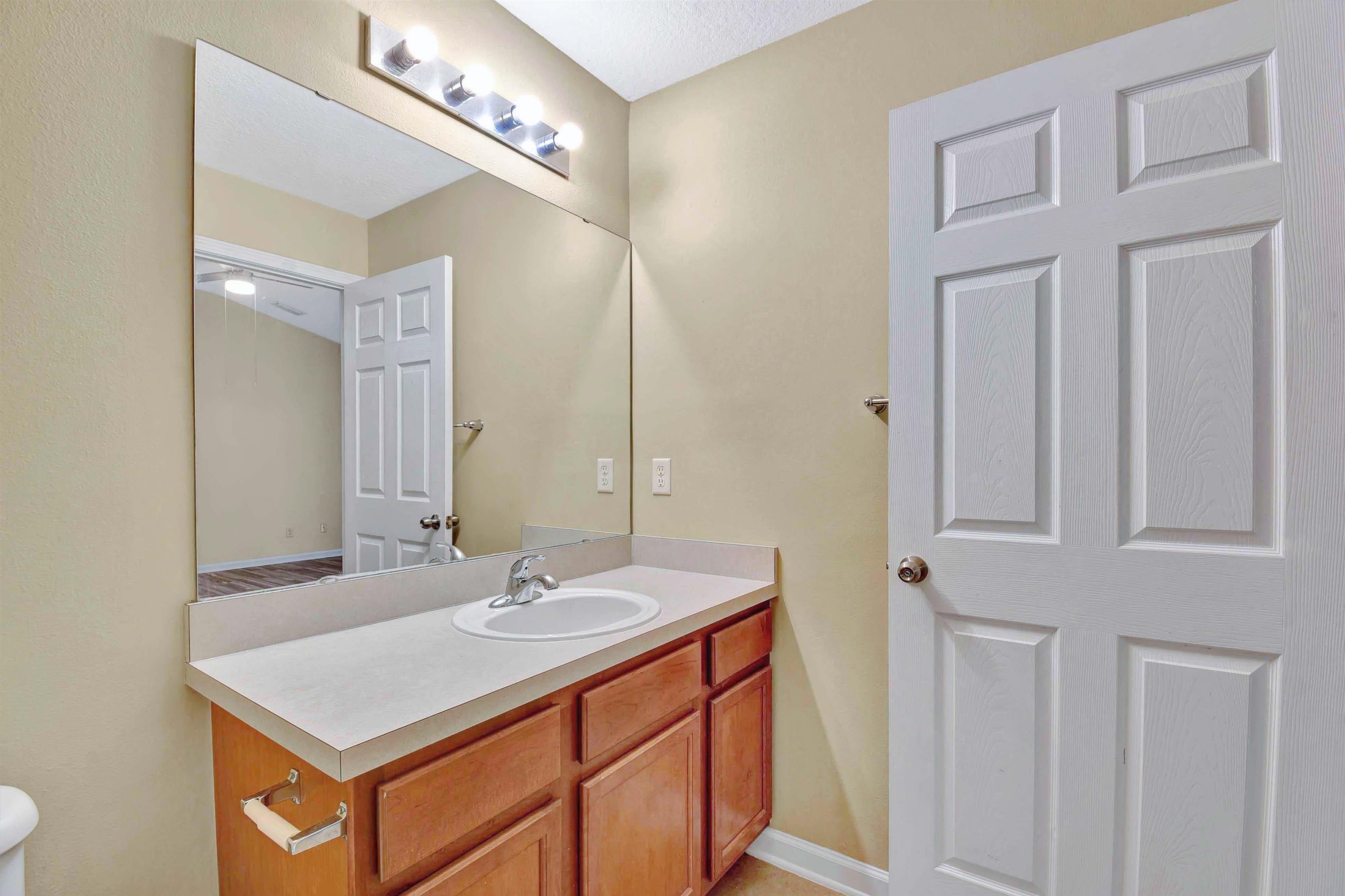 617 Golden Lake Loop St. Augustine, FL 32084 - Photo 14 of 25 a bathroom with a sink vanity and a mirror