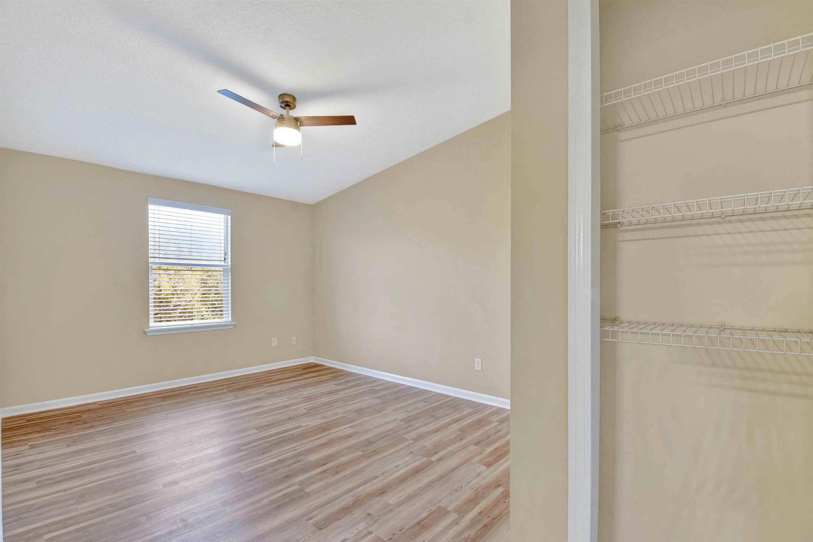 617 Golden Lake Loop St. Augustine, FL 32084 - Photo 15 of 25 a view of an empty room with wooden floor and a window