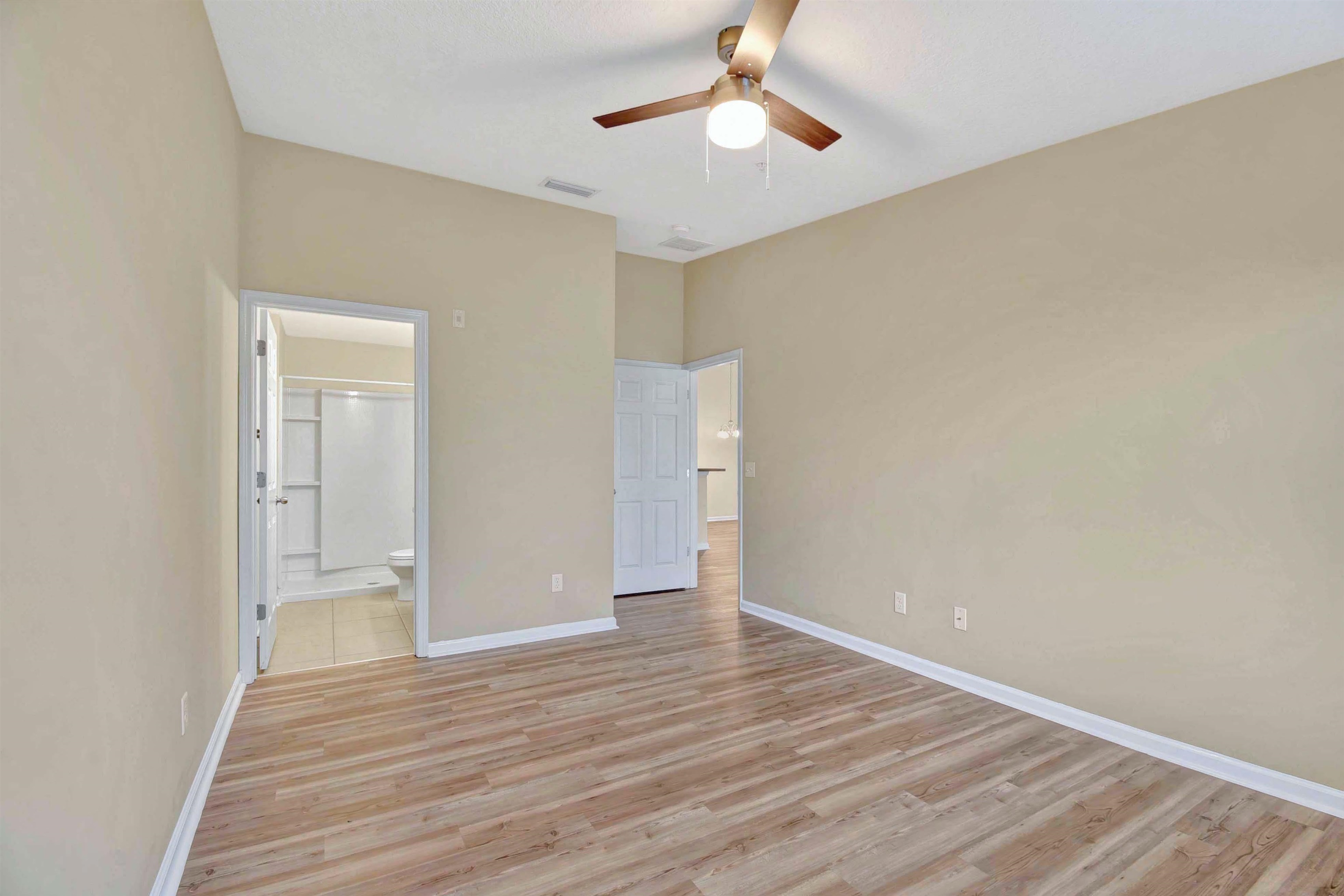 617 Golden Lake Loop St. Augustine, FL 32084 - Photo 16 of 25 a view of an empty room with wooden floor