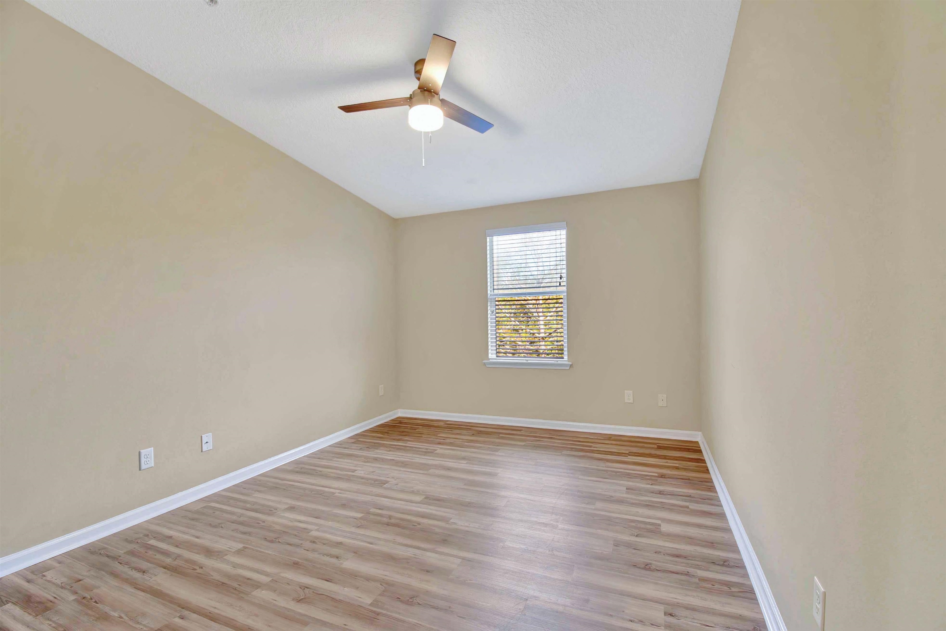 617 Golden Lake Loop St. Augustine, FL 32084 - Photo 17 of 25 wooden floor in an empty room with a window
